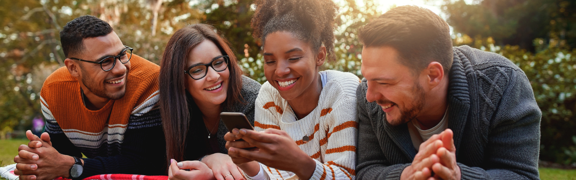 A group of residents talking and looking at a cell phone.